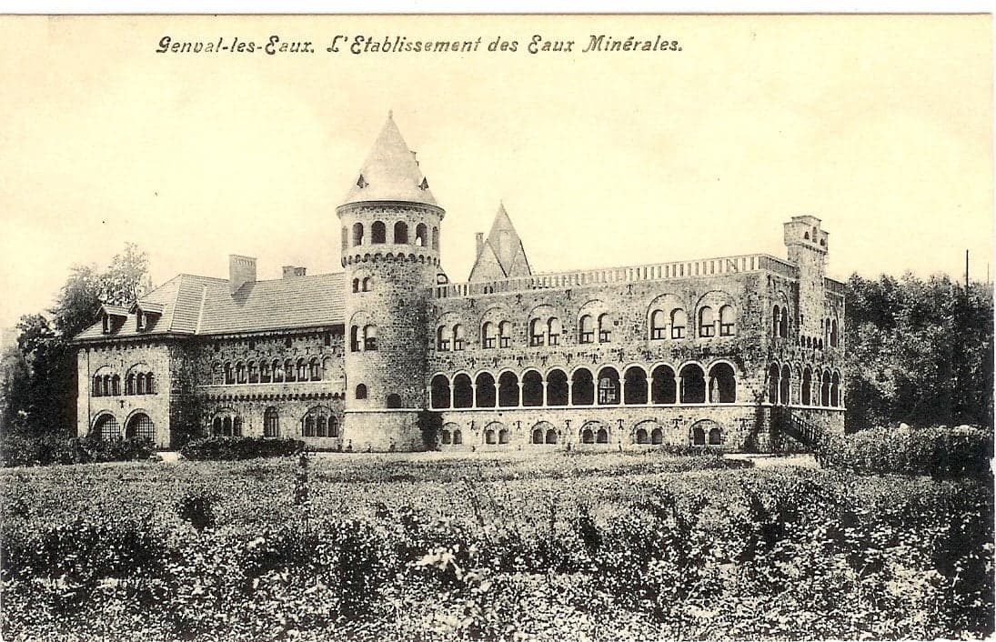 Historic castle-like mineral water establishment exterior with manicured gardens in foreground.