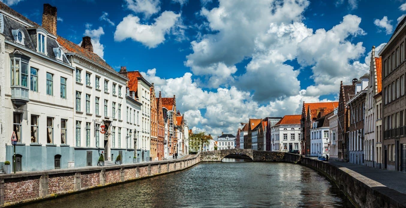 Historic European canal-side neighborhood with colorful facade buildings and waterway.