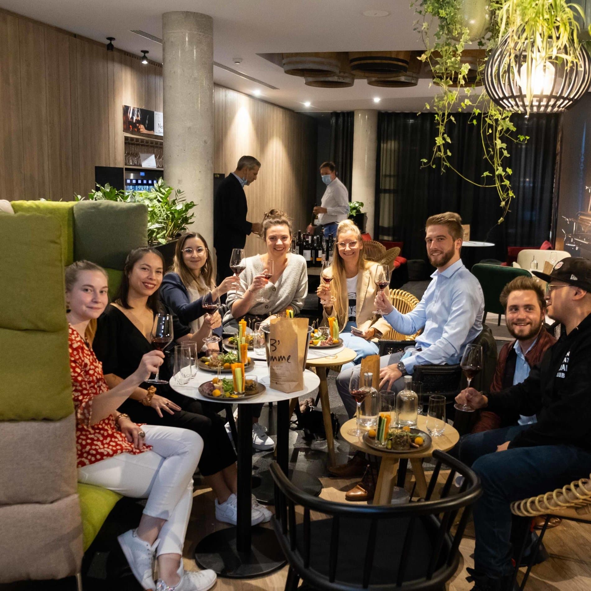 Group gathering in elegant lounge with wine, appetizers, and sophisticated ambiance throughout.