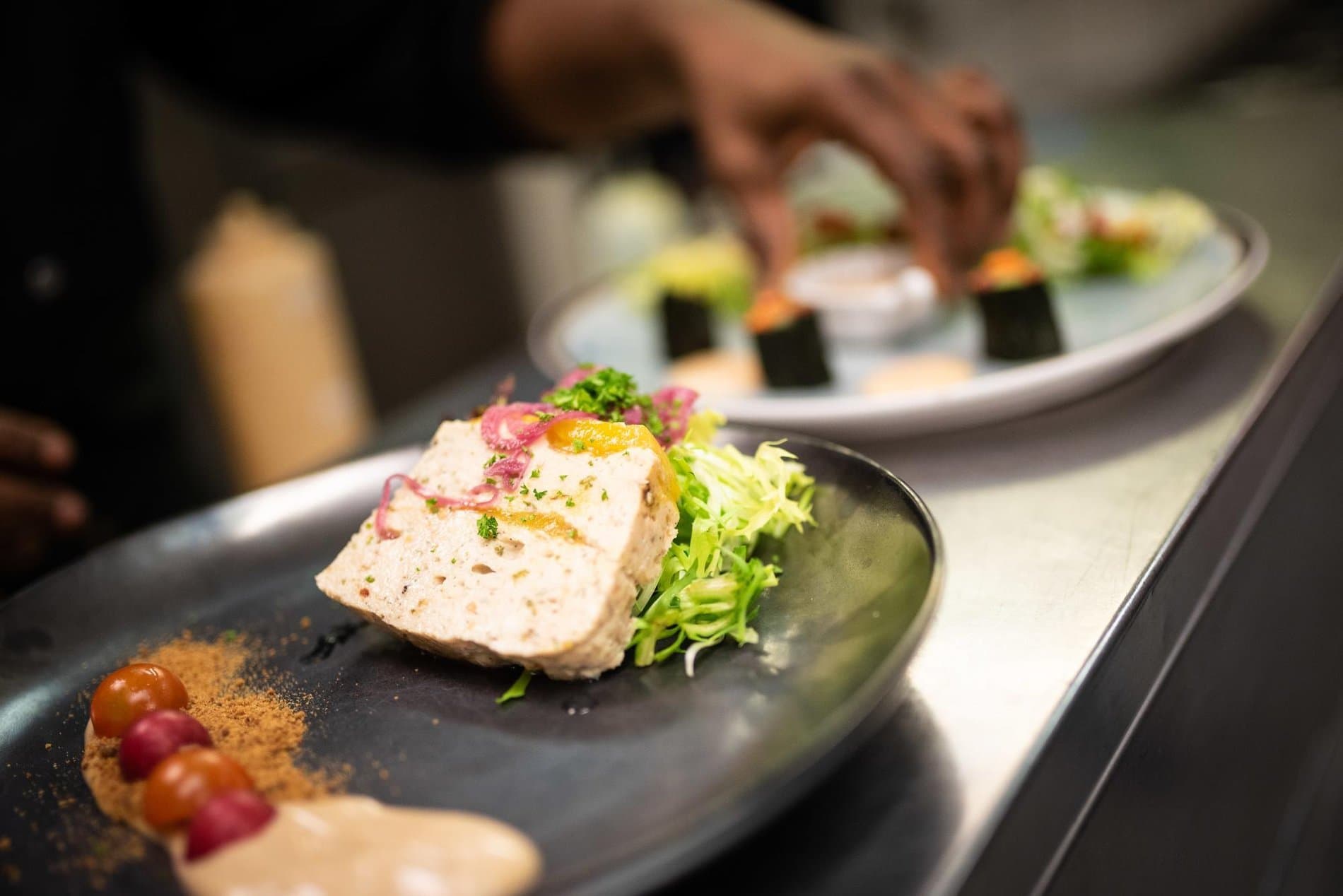 Elegantly plated foie gras appetizer with microgreens and garnish at restaurant